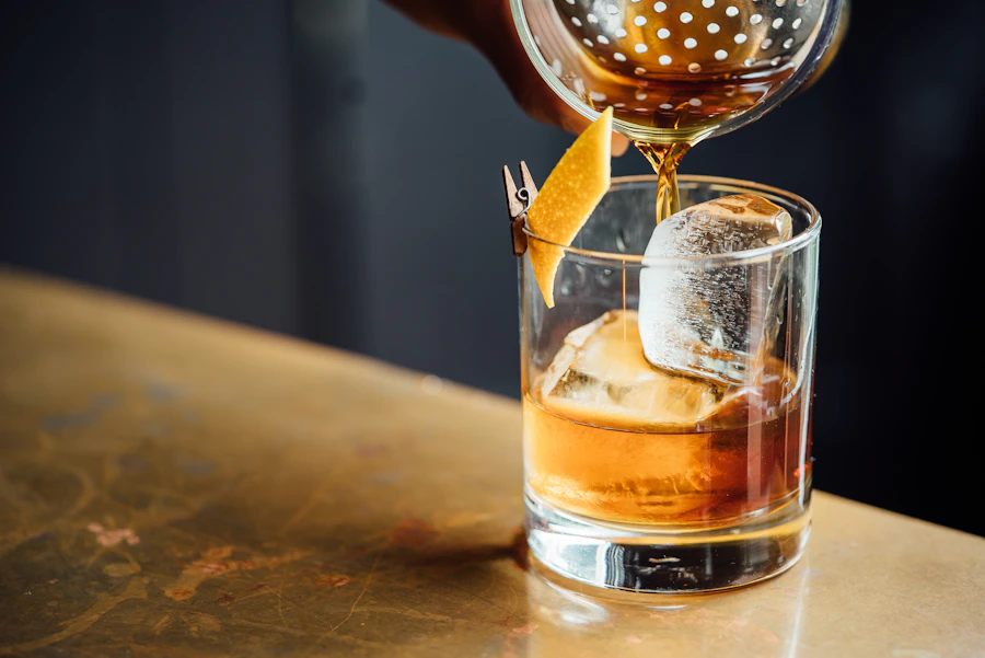 Whiskey tumbler with ice and amber spirit