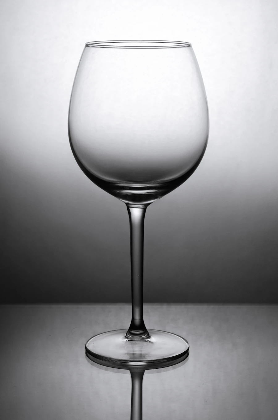 Bordeaux wine glass against a dark background